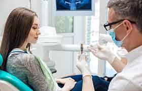 Patient in Beverly talking to dentist about dental implants