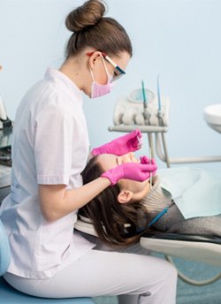 Child smiling and giving dentist a high five