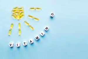 Sunshine made out of supplements next to dice spelling "Vitamin D"